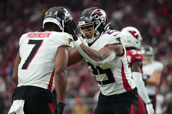 Atlanta Falcons running back Tyler Allgeier (25) congratulates teammate Bijan Robinson (7) on his touchdown against the Arizona Cardinals at State Farm Stadium.